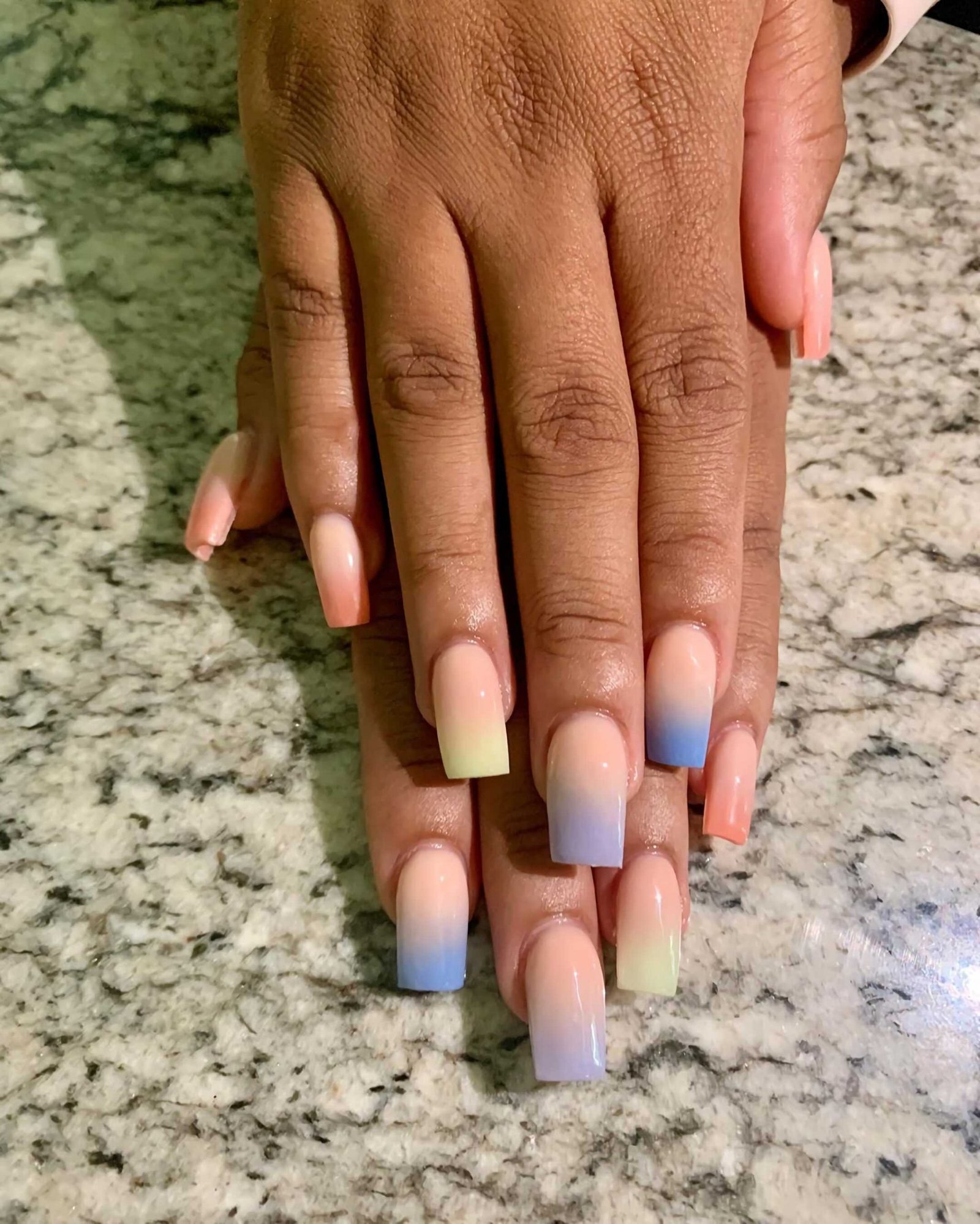 short nails with multi-colored, pastel manicure