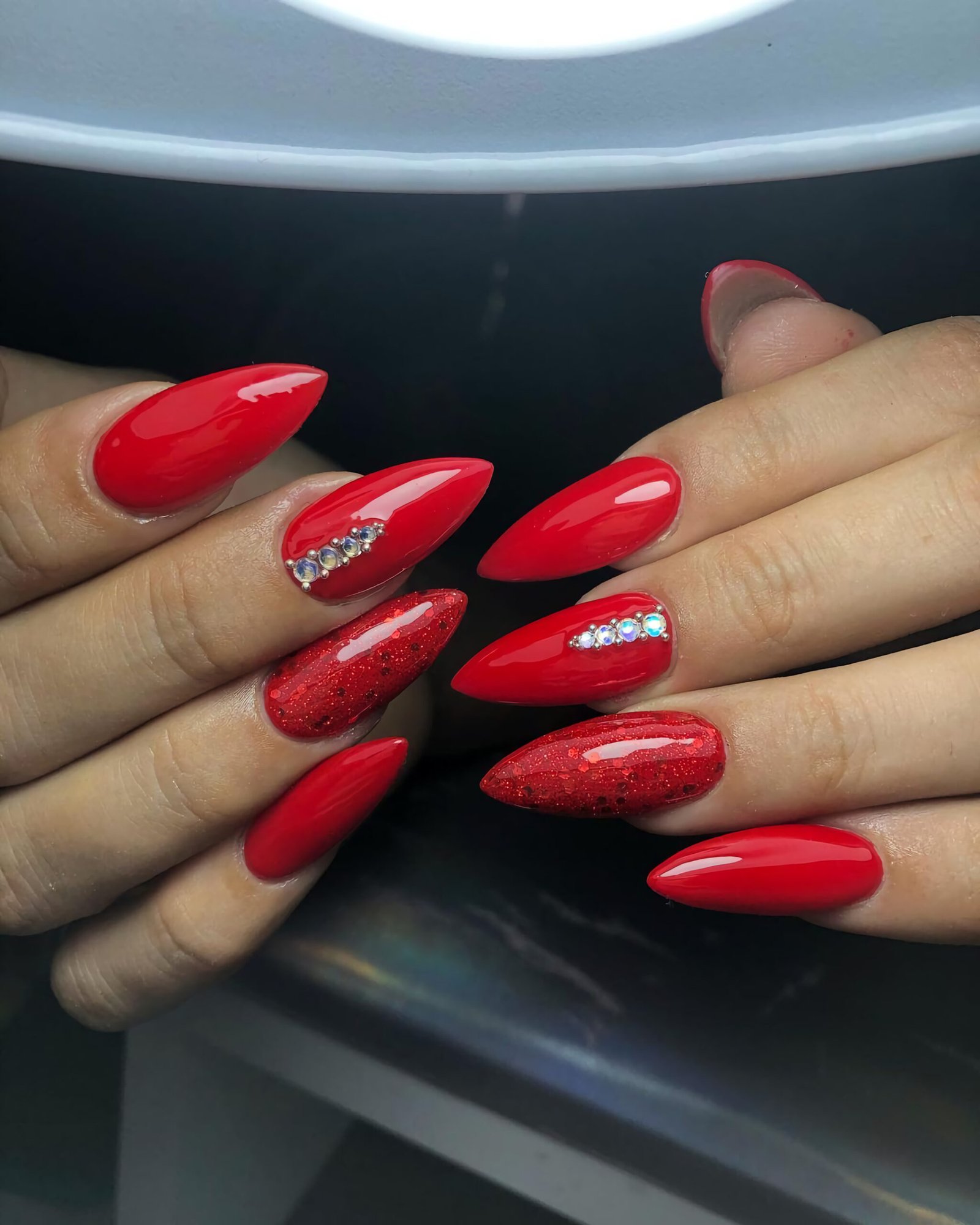 Stylish red nails with precious stones